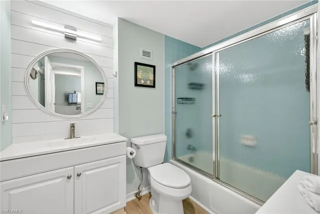 a bathroom with a toilet sink and shower