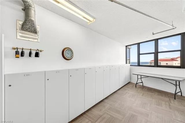 a view of workspace with window and cabinet