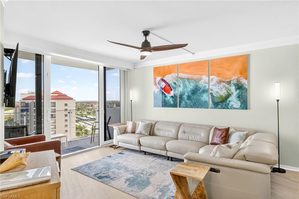 58 North Collier Boulevard, Unit 1606 Marco Island, FL 34145 - Photo 3 of 37 a living room with furniture and a large window