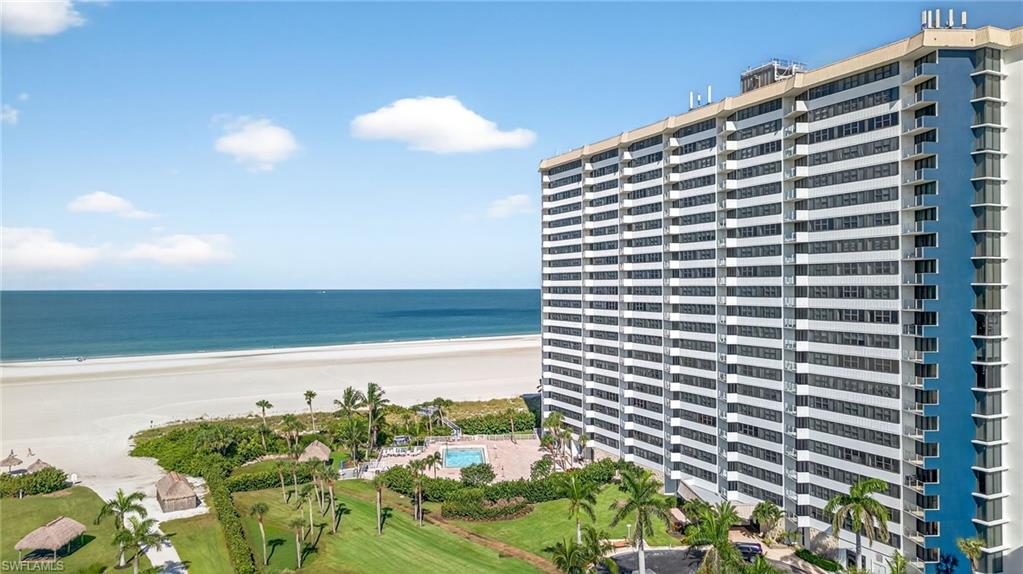 58 North Collier Boulevard, Unit 1606 Marco Island, FL 34145 - Photo 32 of 37 a view of a tall building with a garden