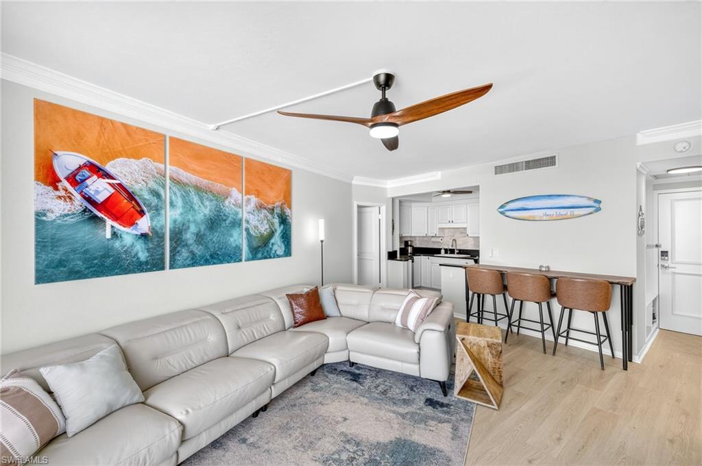 58 North Collier Boulevard, Unit 1606 Marco Island, FL 34145 - Photo 4 of 37 a living room with furniture and a flat screen tv