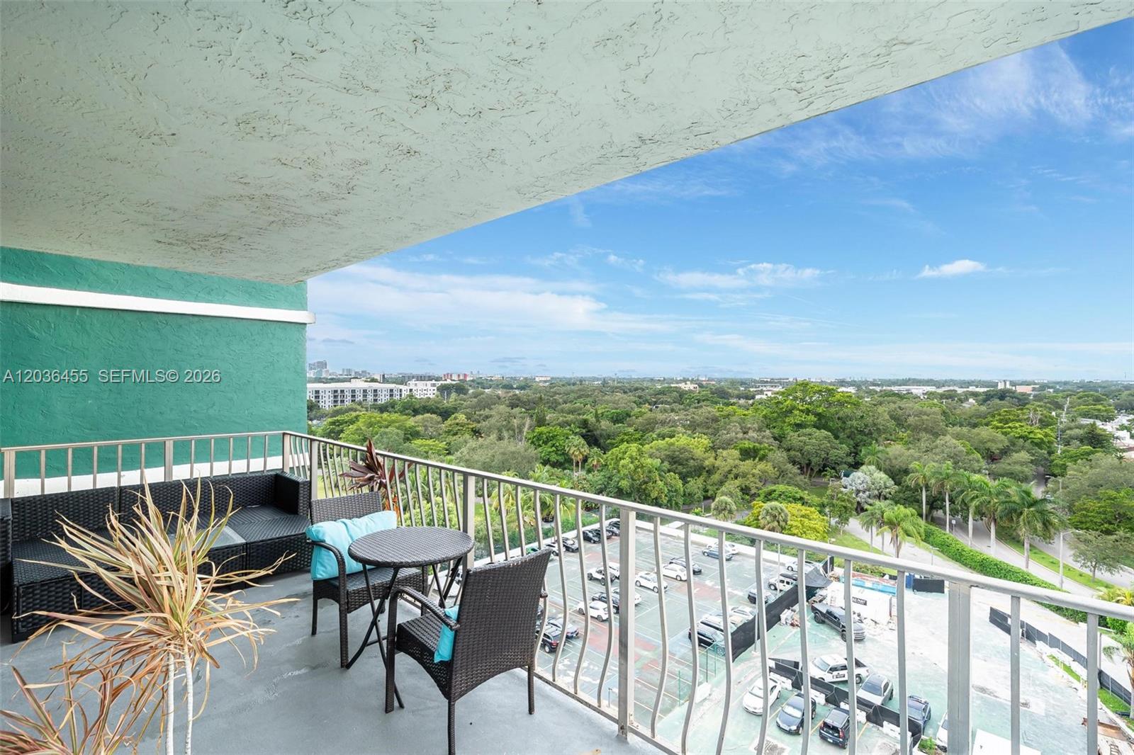 780 Northeast 69th Street, Unit 1010 Miami, FL 33138 - Photo 16 of 31 a balcony with wooden floor outdoor seating and city view