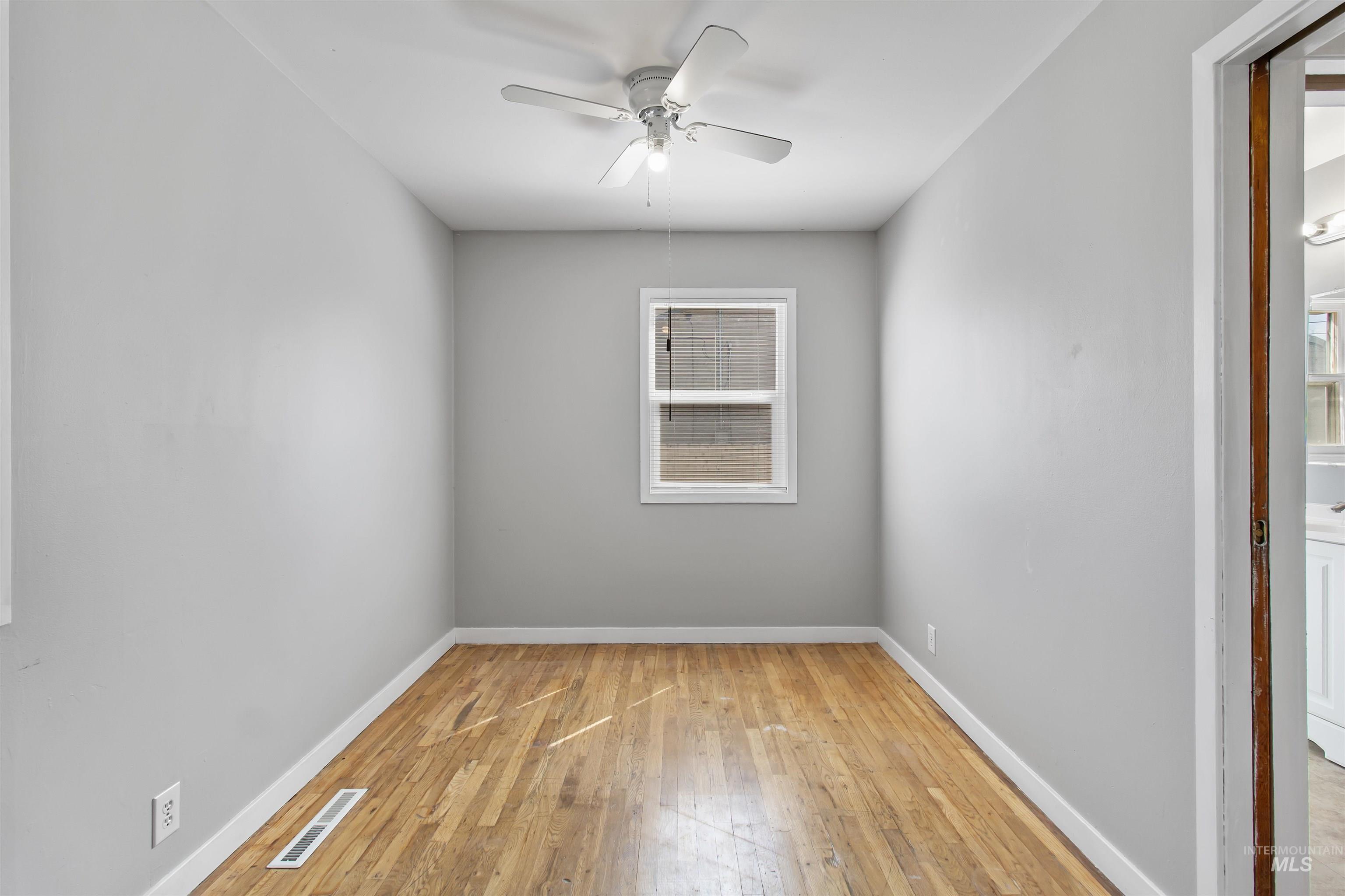 412 Madison Street Twin Falls, ID 83301 - Photo 12 of 42 Unfurnished room with ceiling fan and light wood finished floors