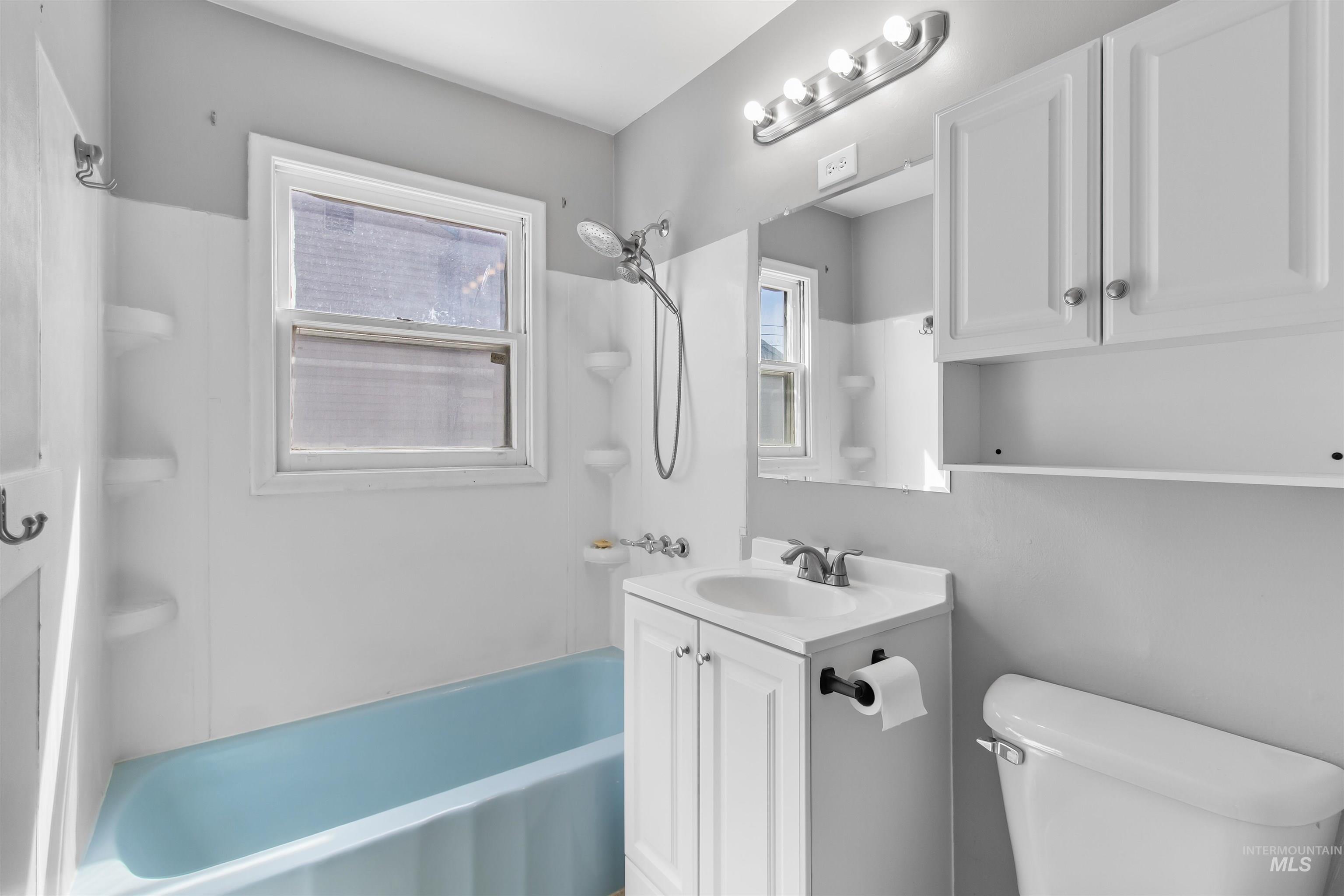 412 Madison Street Twin Falls, ID 83301 - Photo 14 of 42 Full bathroom featuring vanity and shower combination