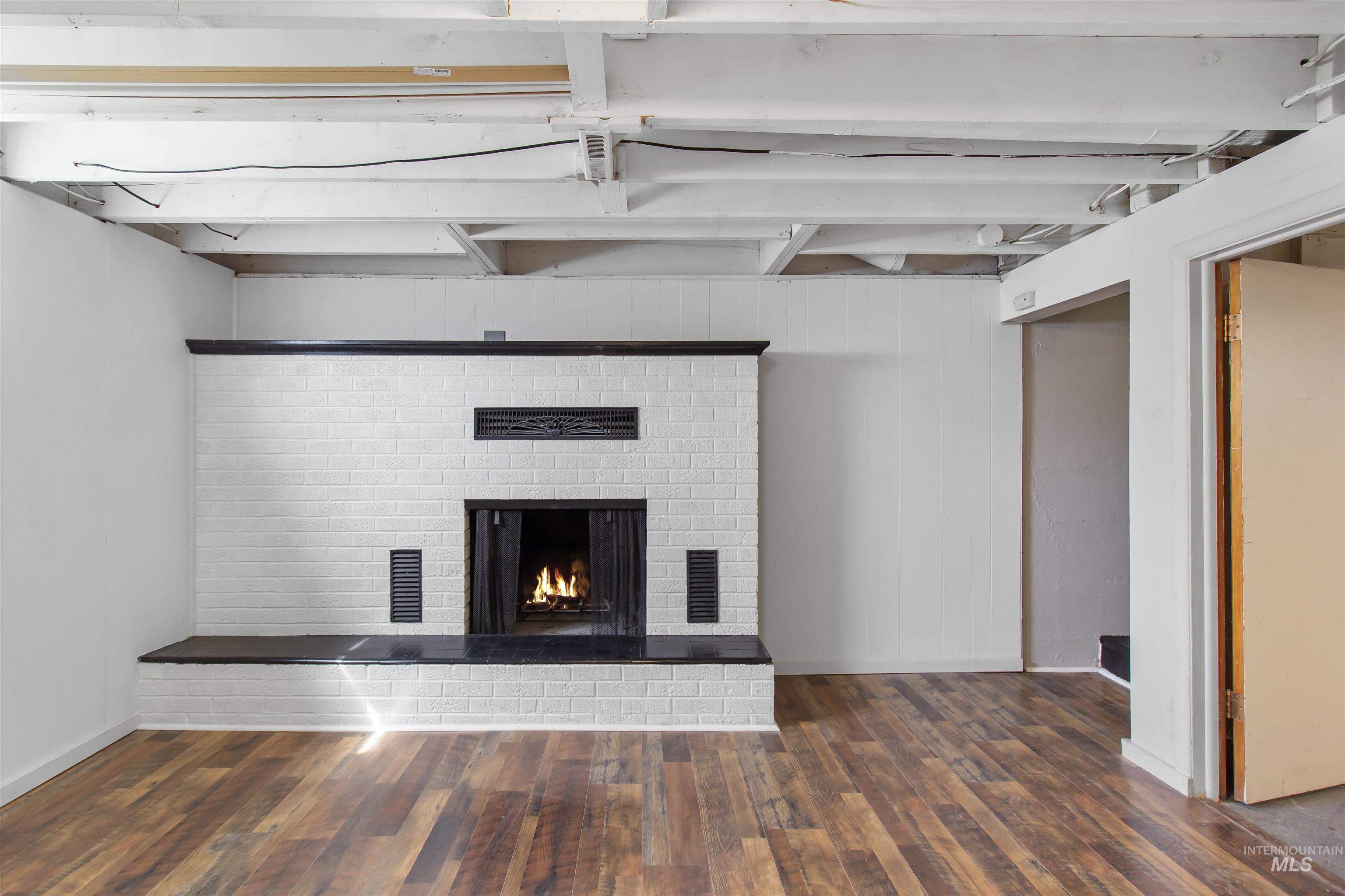412 Madison Street Twin Falls, ID 83301 - Photo 16 of 42 Detailed view of a brick fireplace and wood finished floors