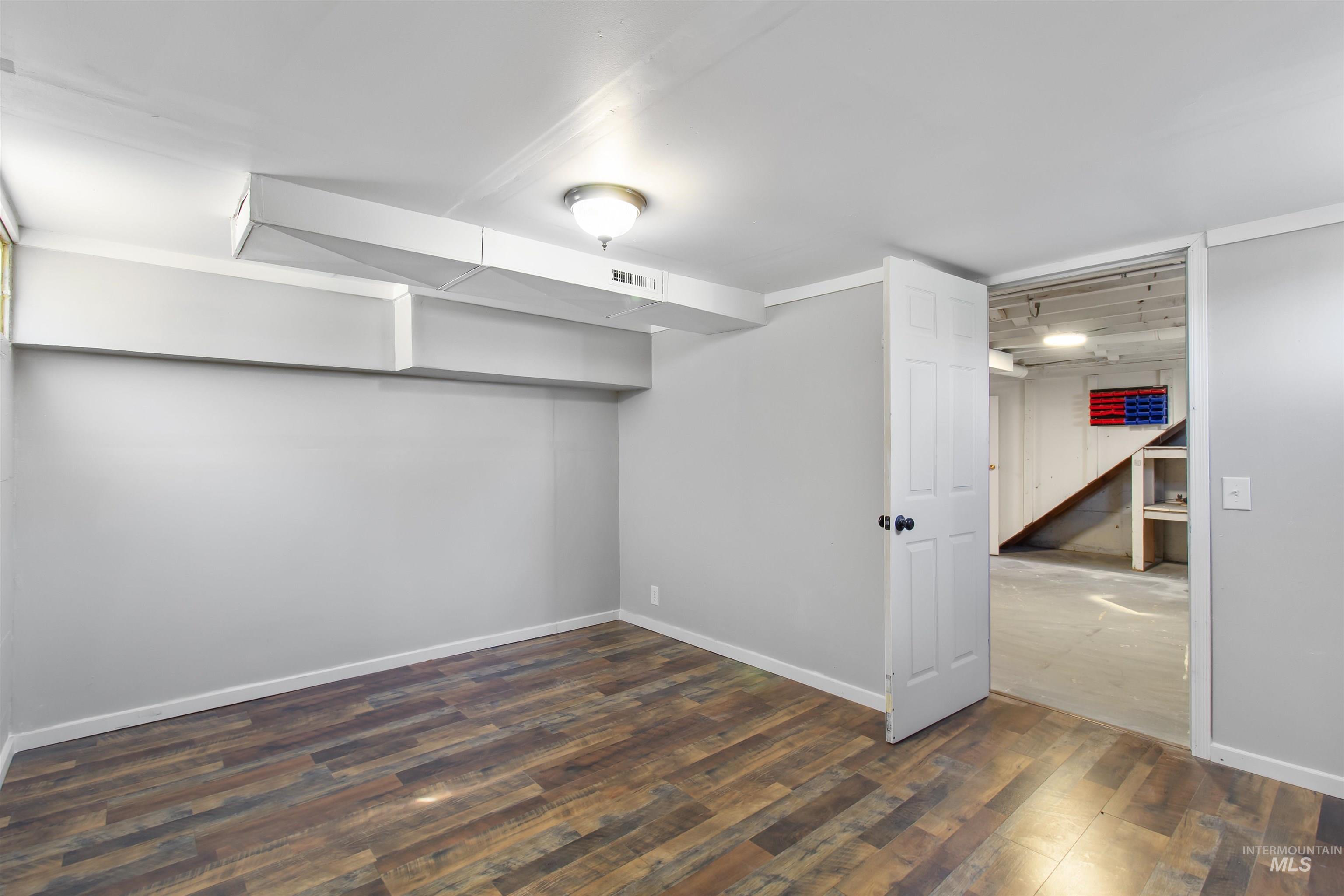 412 Madison Street Twin Falls, ID 83301 - Photo 21 of 42 Finished basement with dark wood-style flooring and baseboards