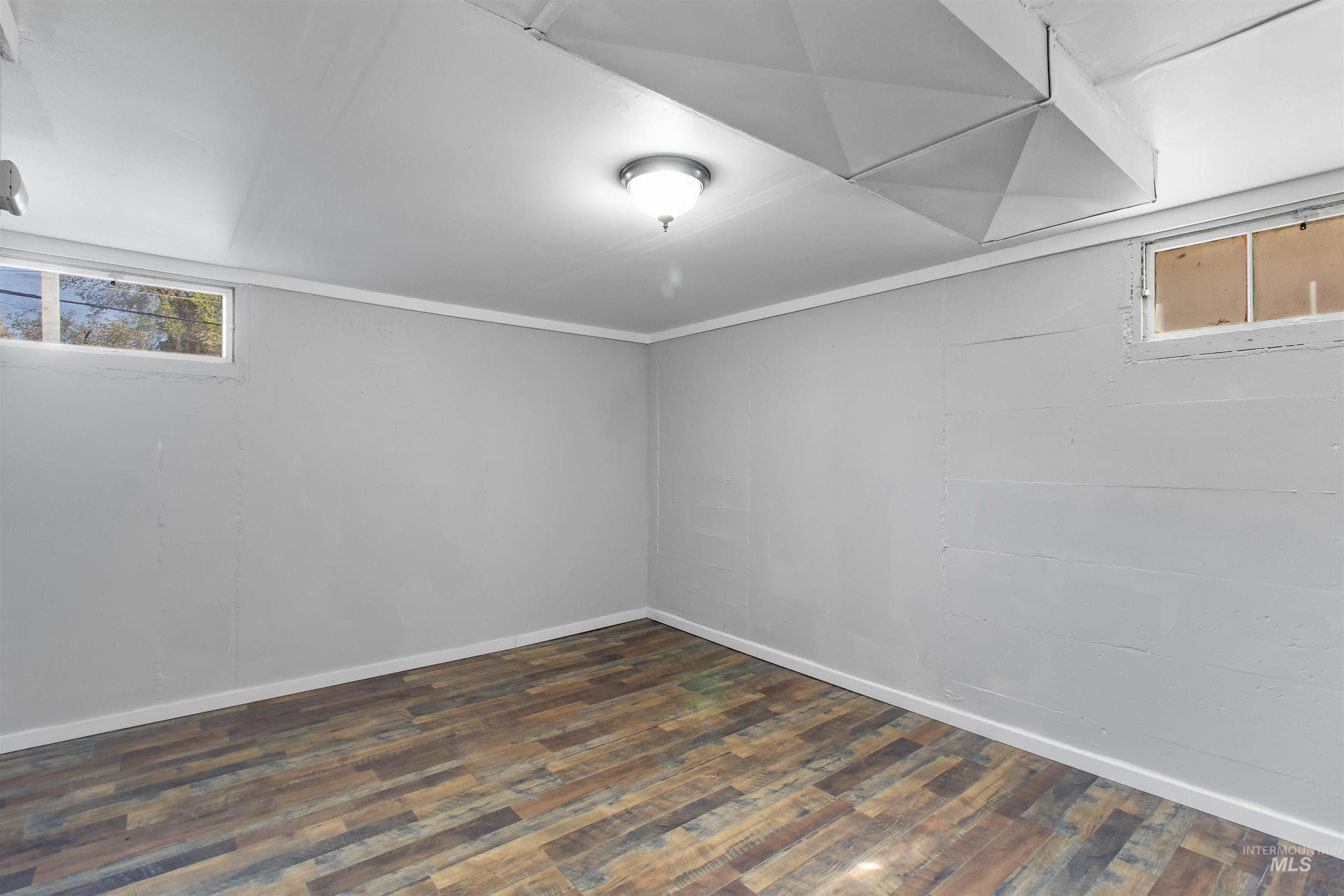 412 Madison Street Twin Falls, ID 83301 - Photo 22 of 42 Basement featuring dark wood-style flooring and baseboards