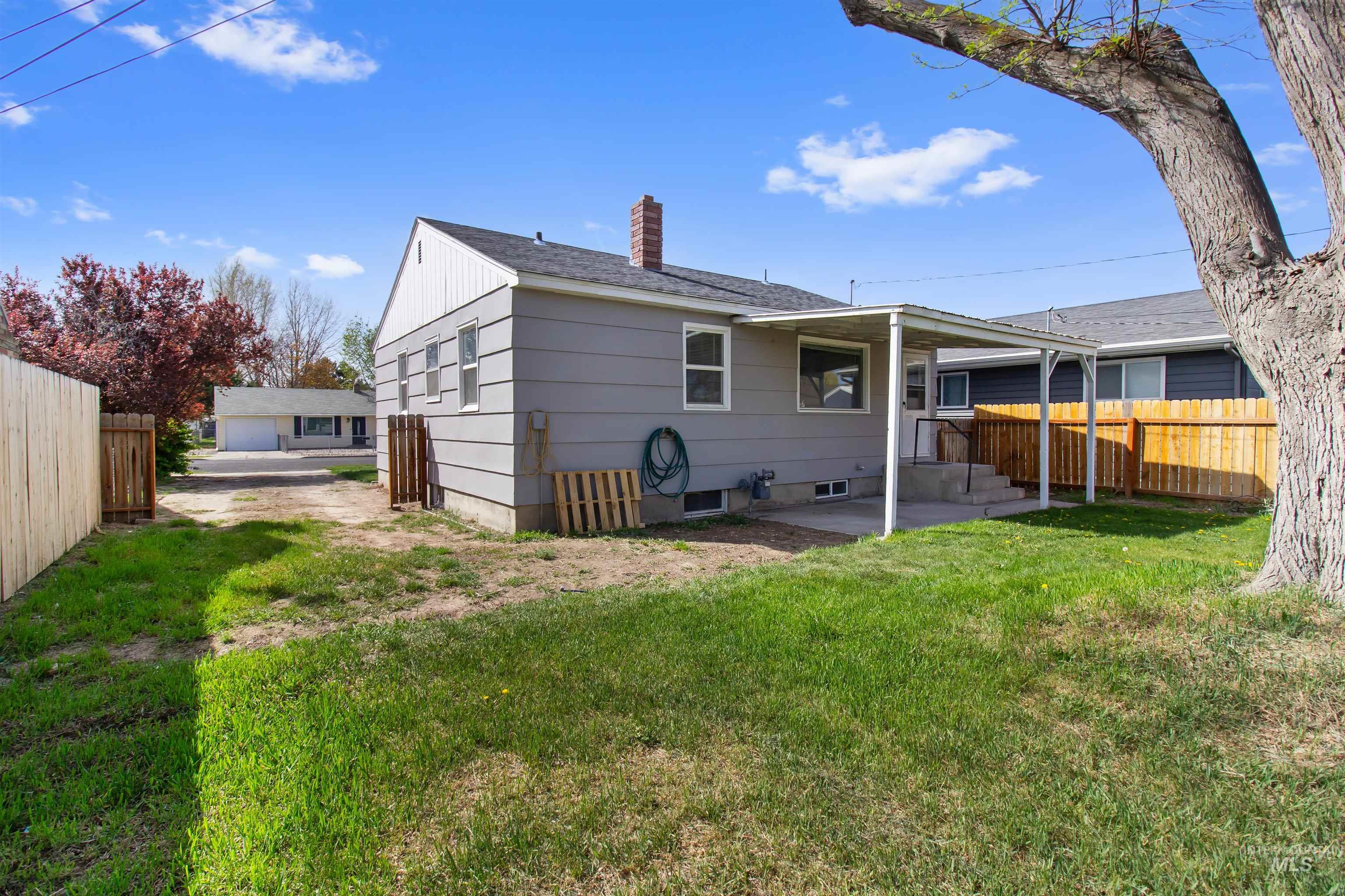 412 Madison Street Twin Falls, ID 83301 - Photo 29 of 42 Back of property with a patio area, a chimney, and roof with shingles