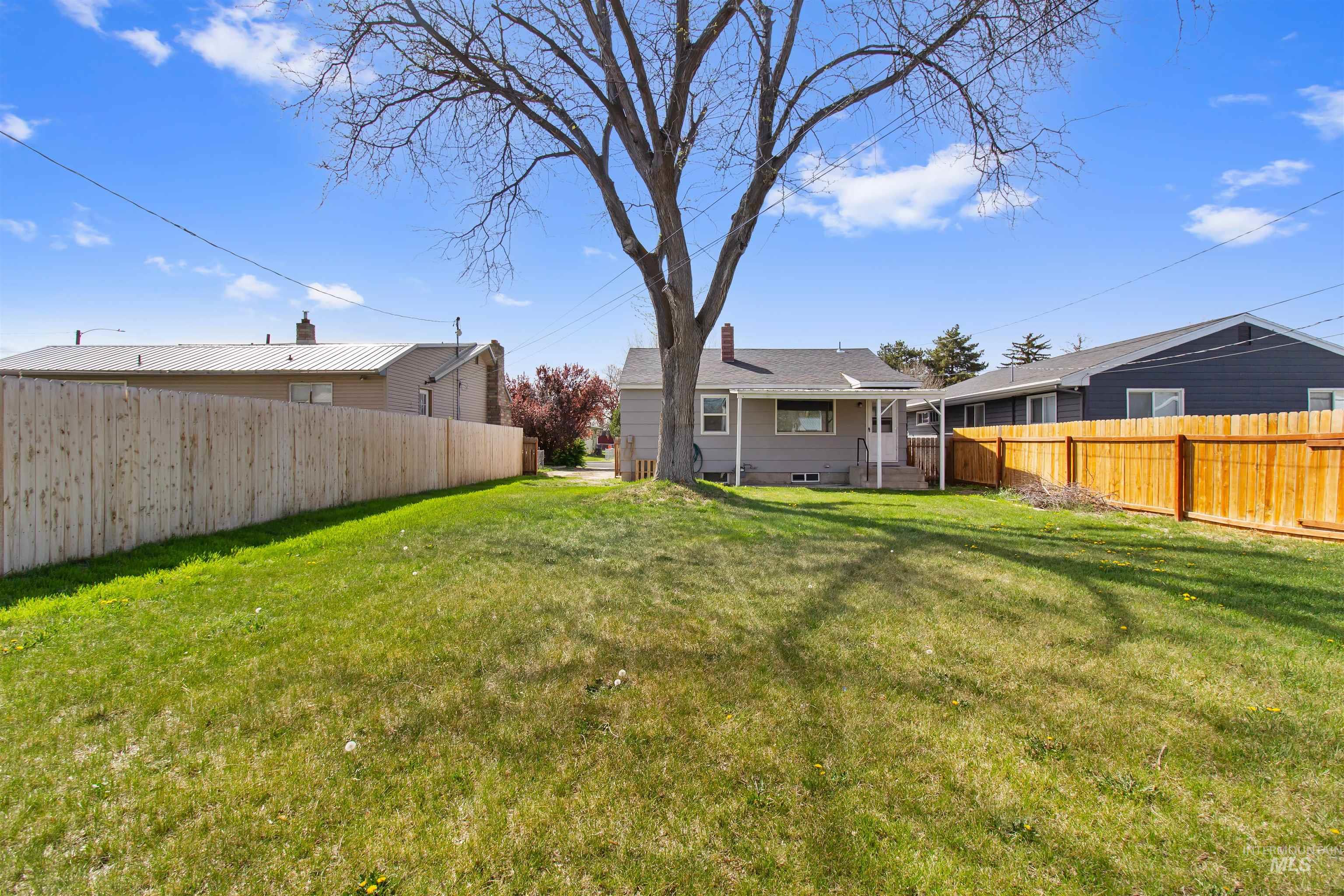 412 Madison Street Twin Falls, ID 83301 - Photo 30 of 42 Rear view of property featuring a fenced backyard and a patio area