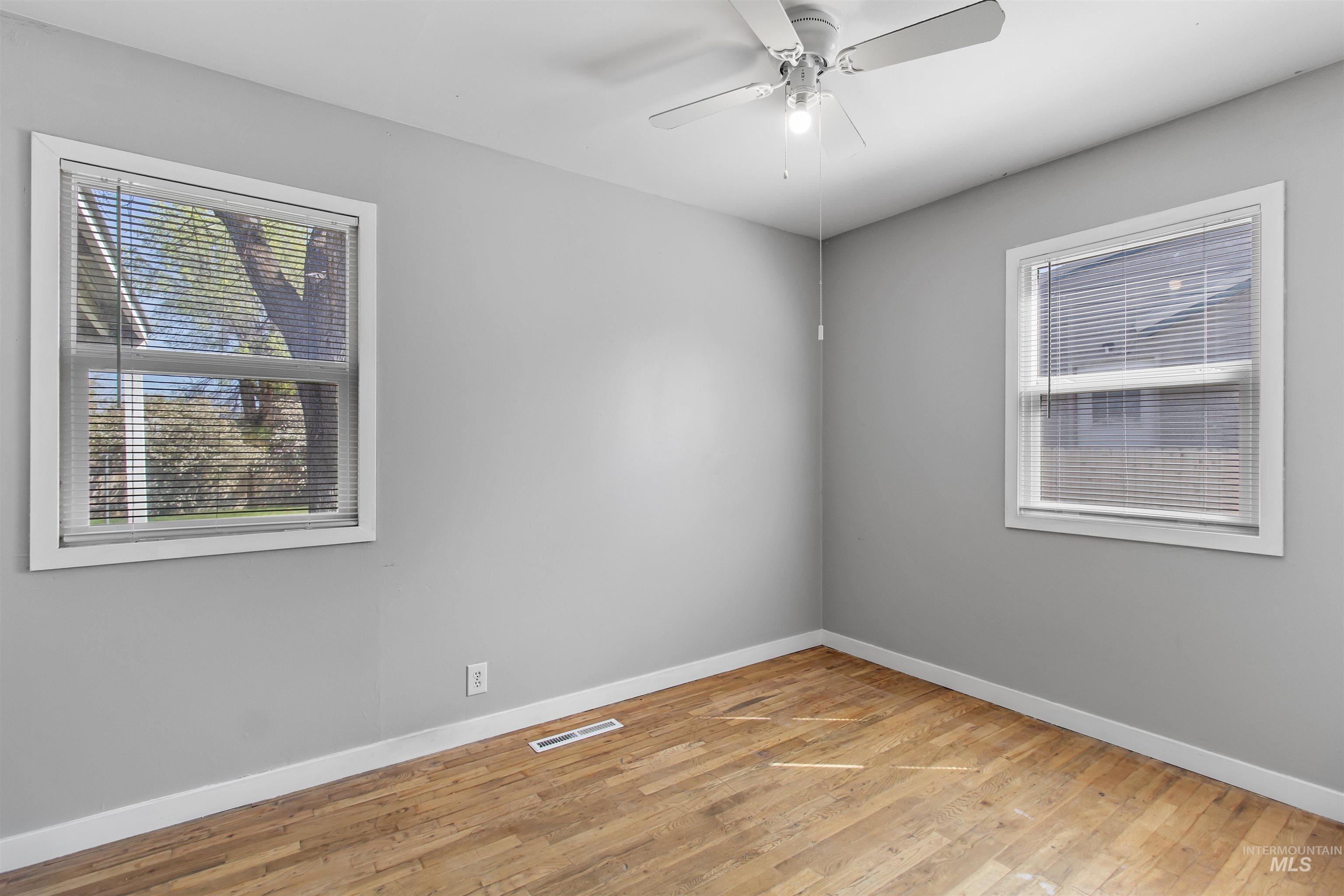 412 Madison Street Twin Falls, ID 83301 - Photo 10 of 42 Unfurnished room with light wood finished floors and a ceiling fan