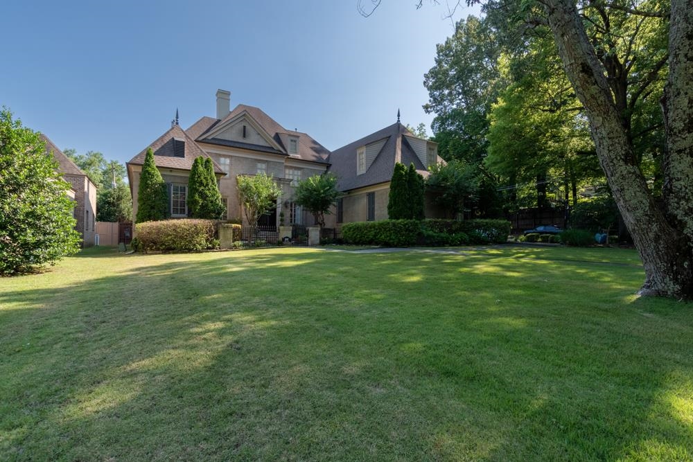 5097 Cole Road Memphis, TN 38117 - Photo 1 of 25 a front view of a house with garden