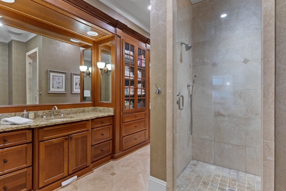 5097 Cole Road Memphis, TN 38117 - Photo 13 of 25 a bathroom with a granite countertop sink a mirror and a shower