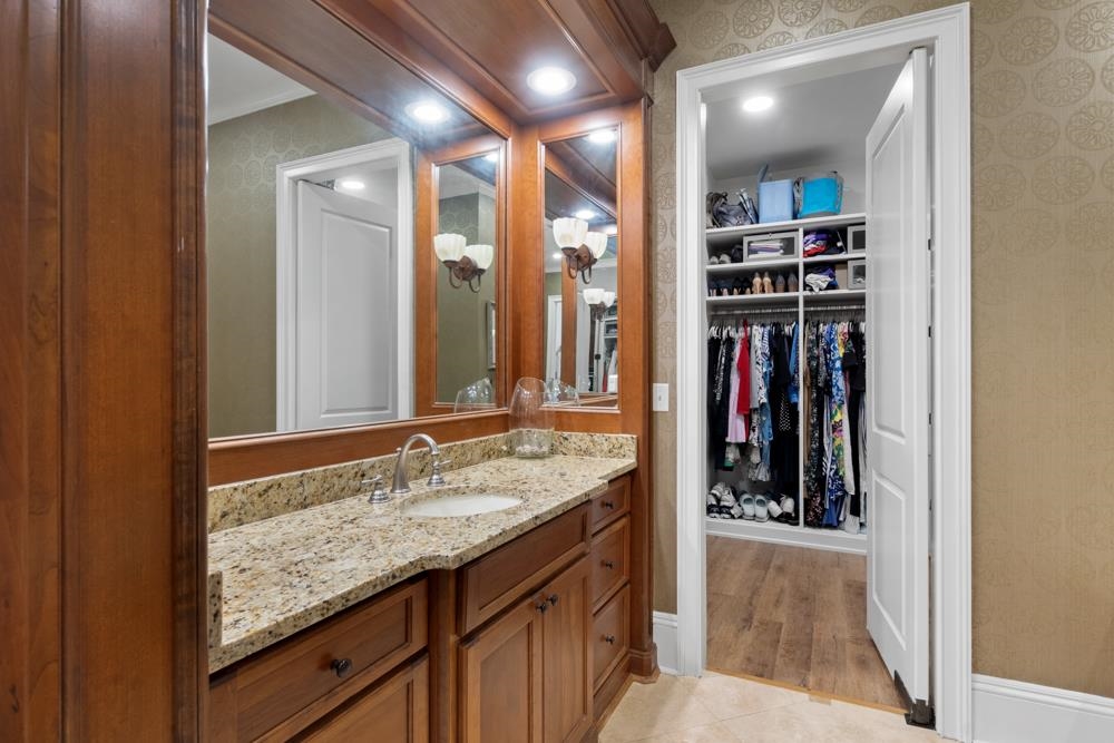 5097 Cole Road Memphis, TN 38117 - Photo 14 of 25 a bathroom with a granite countertop sink and a mirror