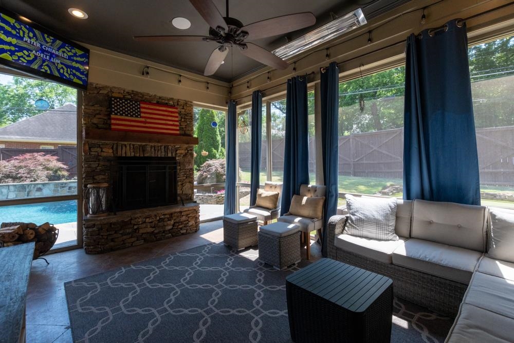 5097 Cole Road Memphis, TN 38117 - Photo 20 of 25 a living room with furniture a flat screen tv and a floor to ceiling window