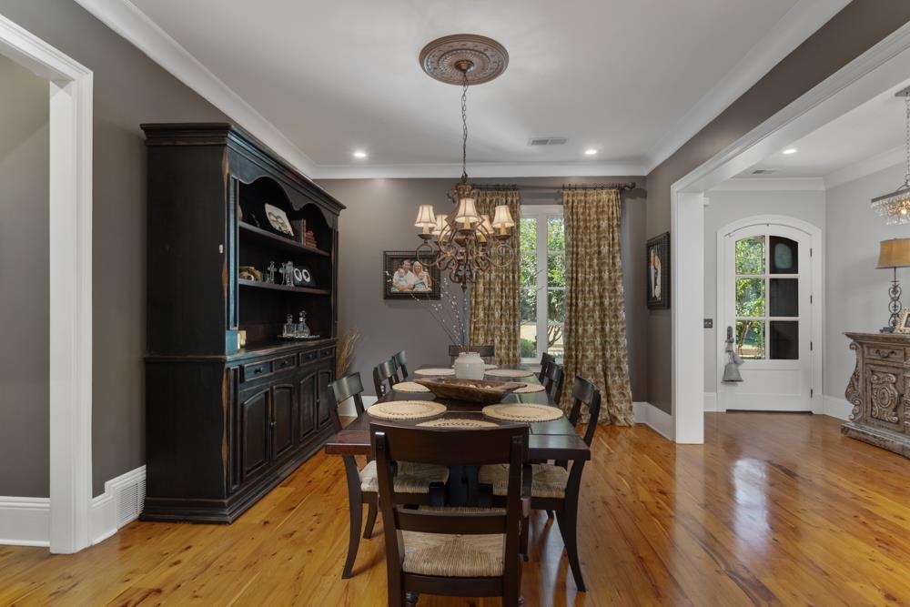5097 Cole Road Memphis, TN 38117 - Photo 3 of 25 a dining room with furniture a chandelier and wooden floor