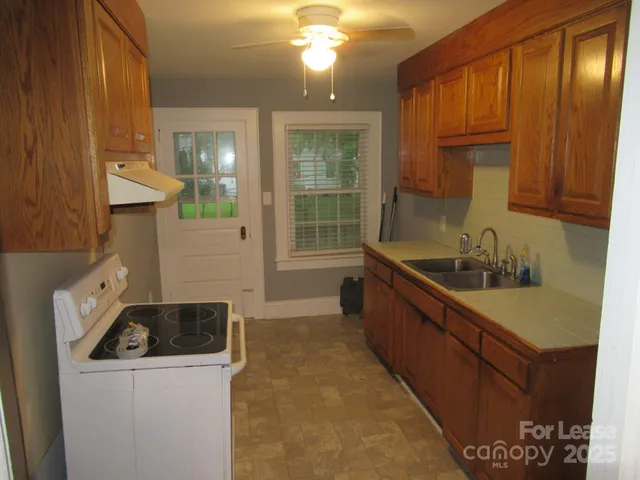 a kitchen that has a sink and a stove in it