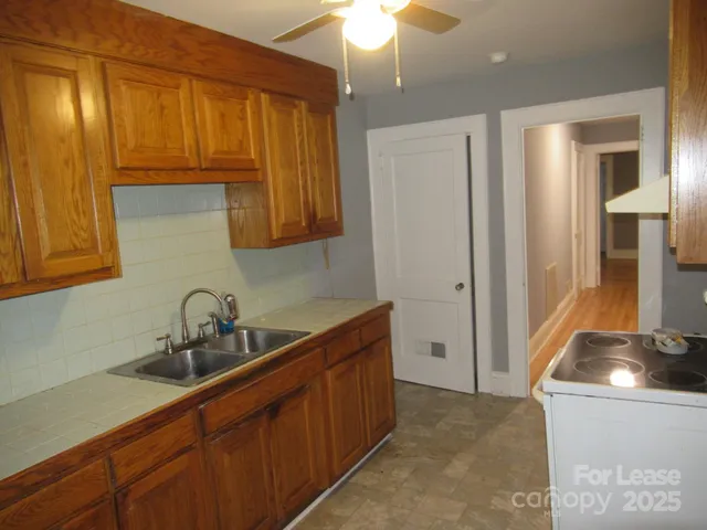a kitchen with stainless steel appliances a sink stove and refrigerator