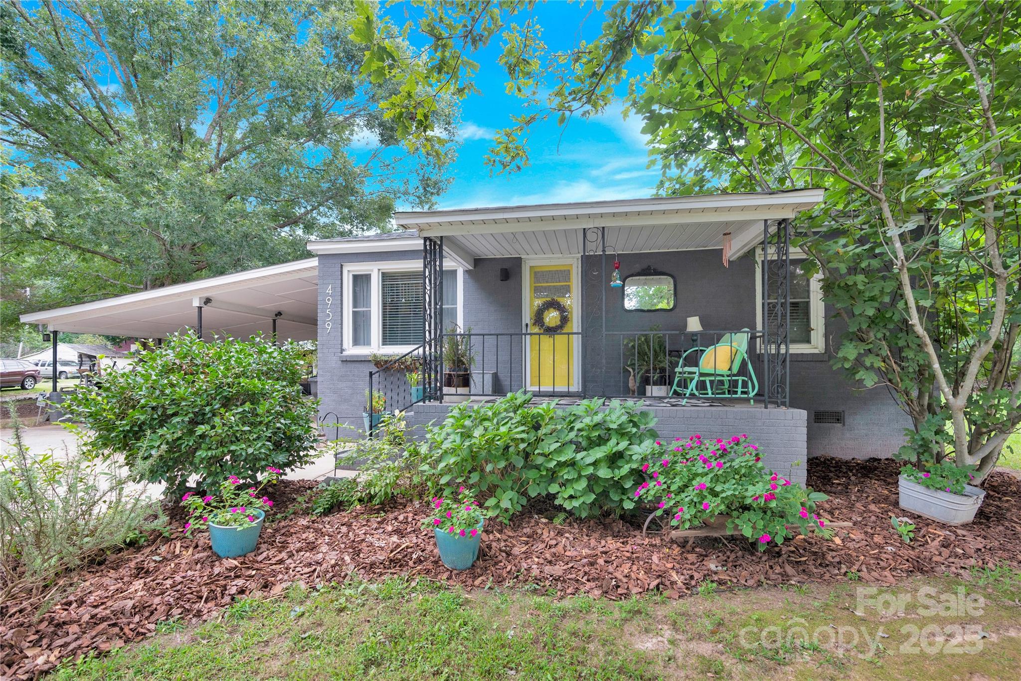 a view of a house with a flower garden