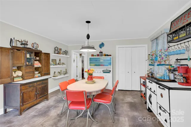 a dining room with furniture and a kitchen view