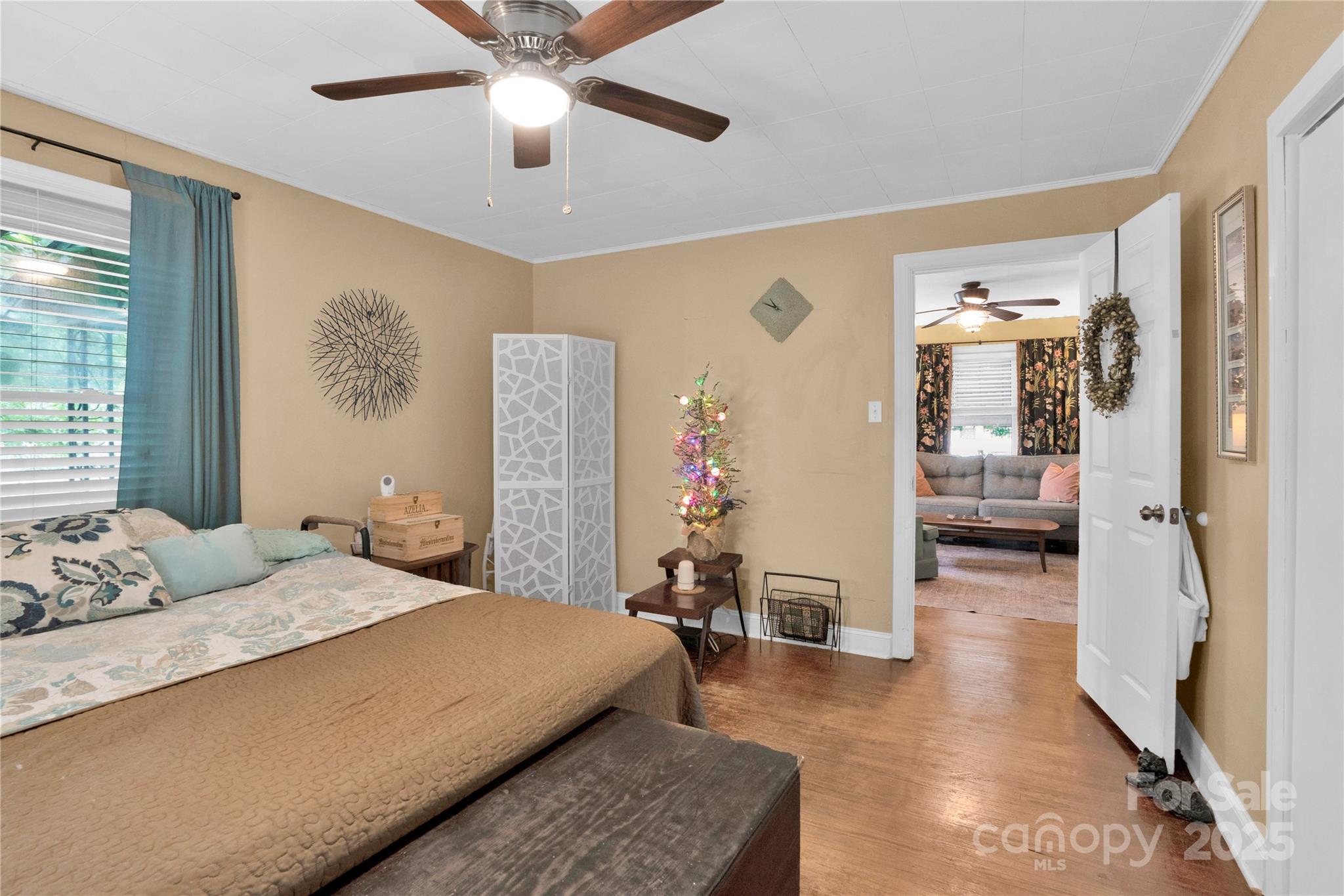 4959 King Wilkinson Road Denver, NC 28037 - Photo 14 of 41 a bedroom with a large bed and a chandelier