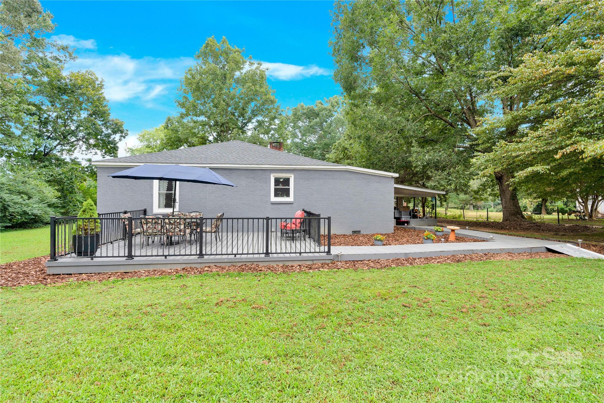 4959 King Wilkinson Road Denver, NC 28037 - Photo 24 of 41 a view of a house with a yard and sitting area