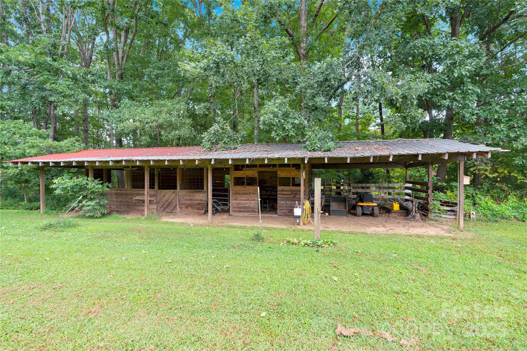 4959 King Wilkinson Road Denver, NC 28037 - Photo 28 of 41 a view of a house with a yard porch and sitting area