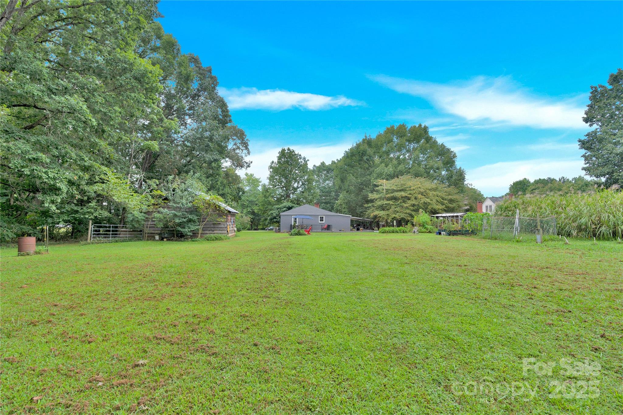 4959 King Wilkinson Road Denver, NC 28037 - Photo 30 of 41 a view of a field of grass and trees