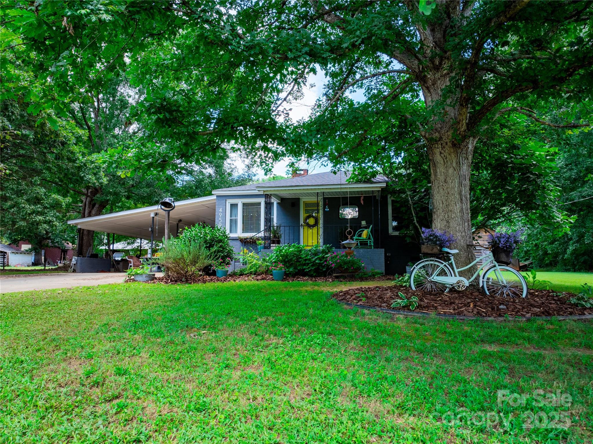 4959 King Wilkinson Road Denver, NC 28037 - Photo 33 of 41 a view of a house with backyard sitting area and garden