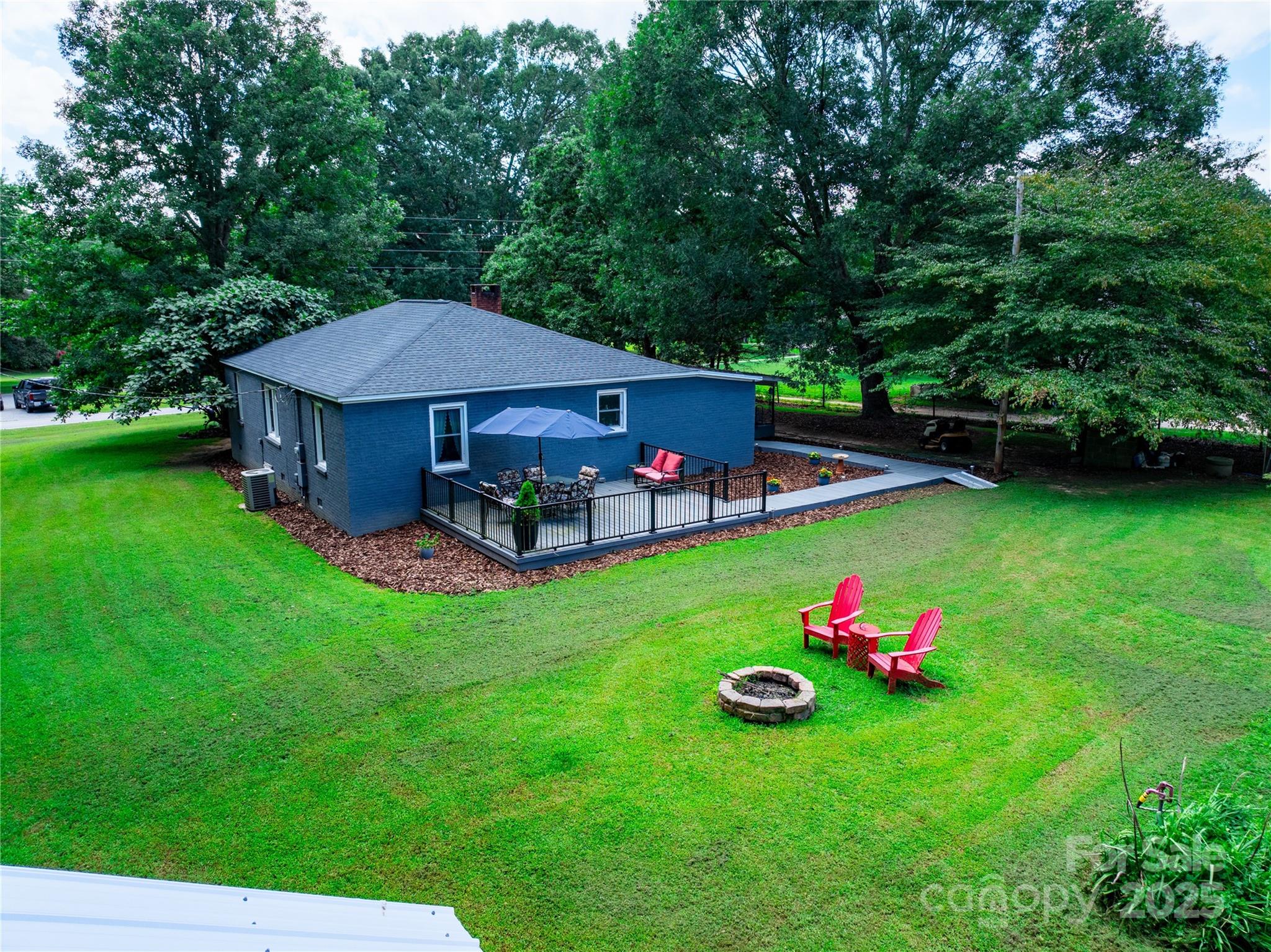 4959 King Wilkinson Road Denver, NC 28037 - Photo 34 of 41 a view of a table and chairs in the back yard