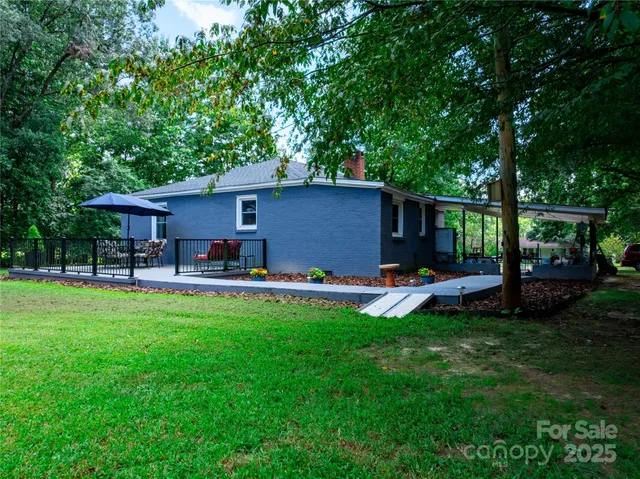 a view of a house with a backyard and a patio