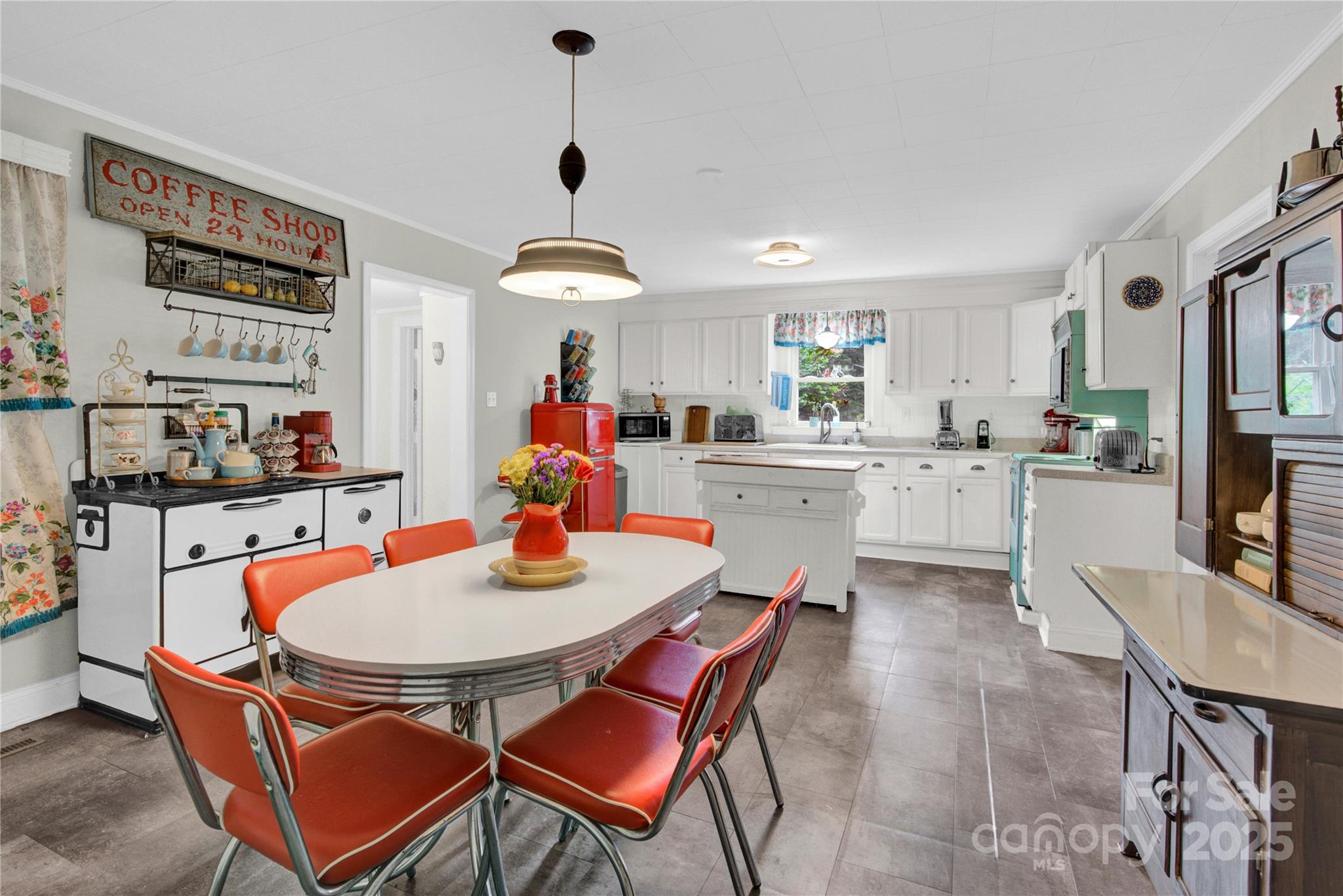 4959 King Wilkinson Road Denver, NC 28037 - Photo 6 of 41 a kitchen with a dining table and chairs