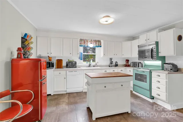 a kitchen with cabinets a sink and appliances