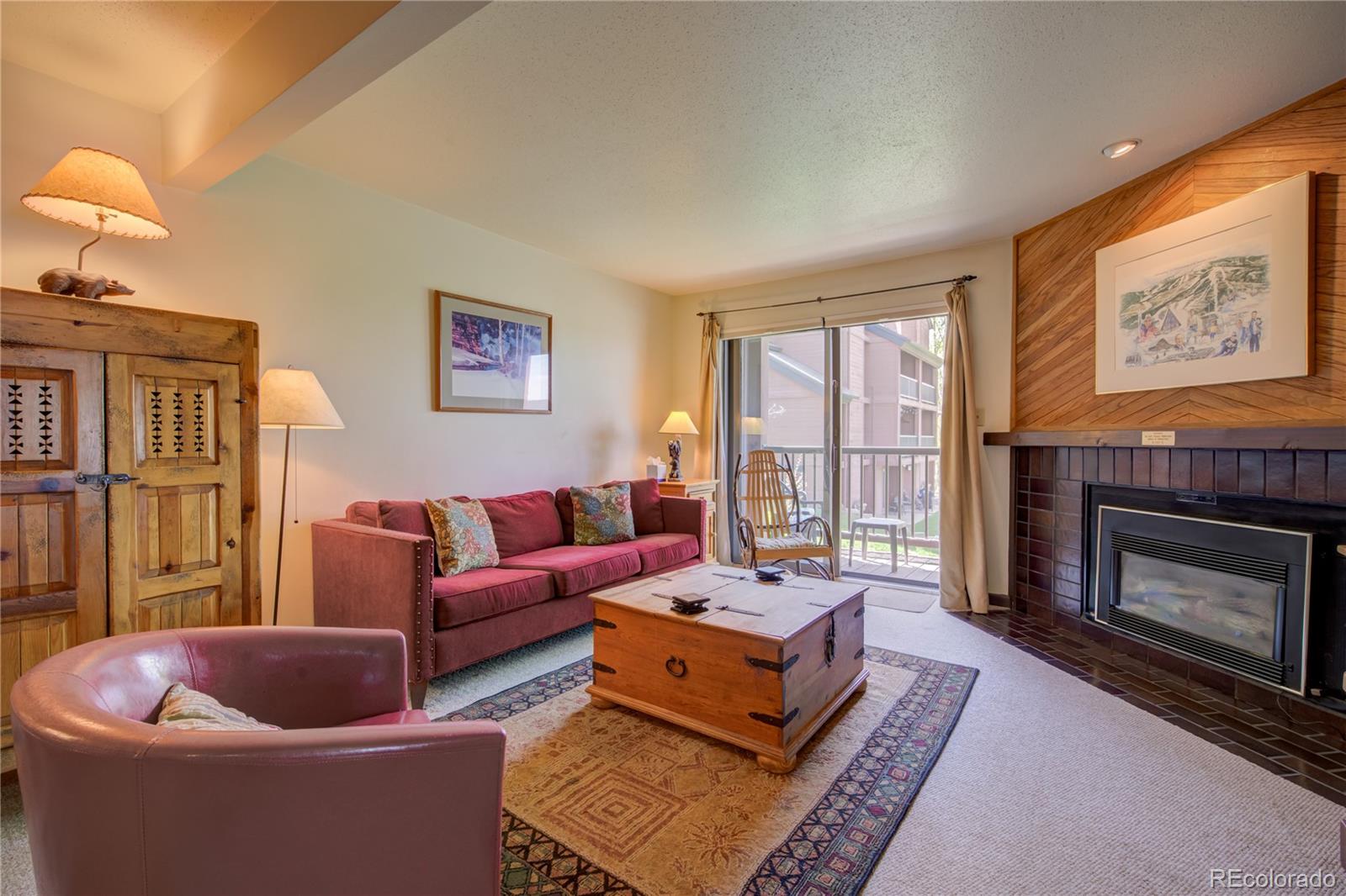 a living room with furniture a window and a fireplace