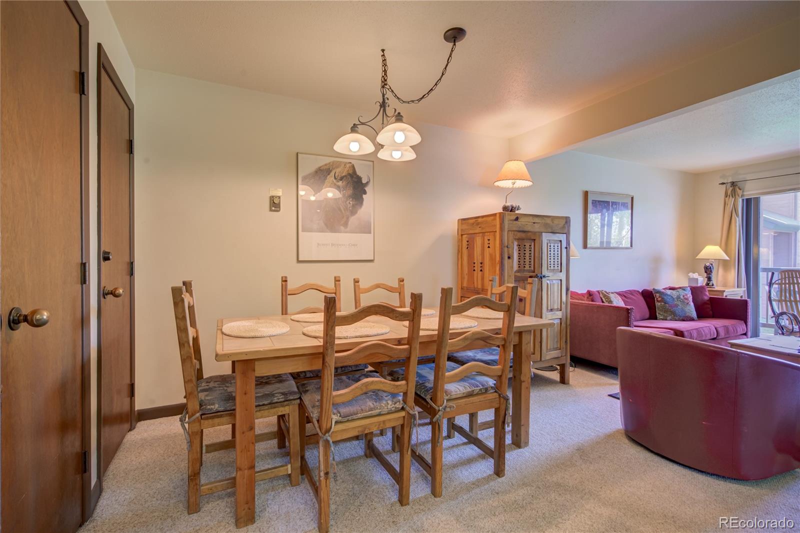 2015 Walton Creek Road, Unit 114 Steamboat Springs, CO 80487 - Photo 11 of 29 a view of a dining room with furniture and a chandelier