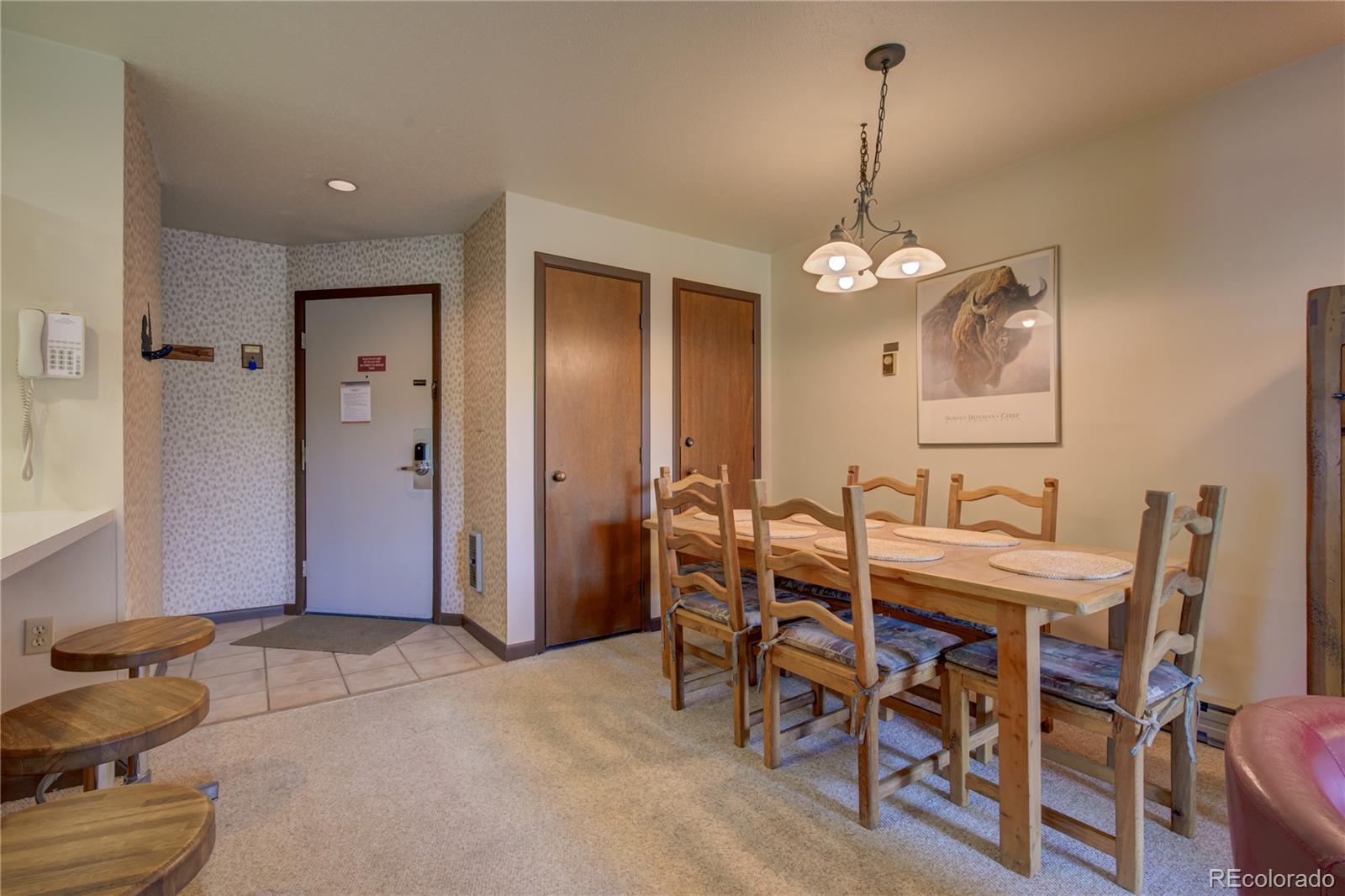 2015 Walton Creek Road, Unit 114 Steamboat Springs, CO 80487 - Photo 12 of 29 a view of a dining room with furniture and chandelier