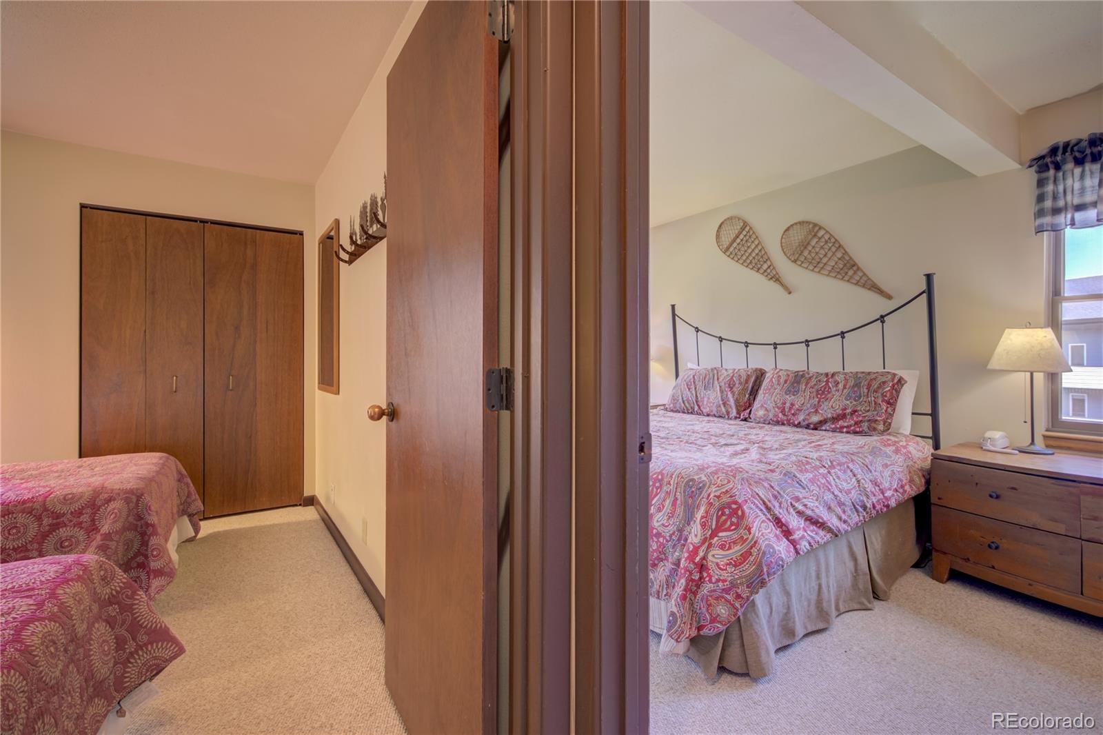 2015 Walton Creek Road, Unit 114 Steamboat Springs, CO 80487 - Photo 13 of 29 a bedroom with a bed dresser and a window