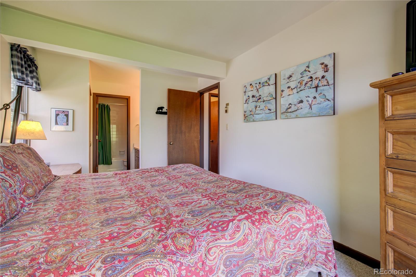 2015 Walton Creek Road, Unit 114 Steamboat Springs, CO 80487 - Photo 15 of 29 a bedroom with a large bed and a window