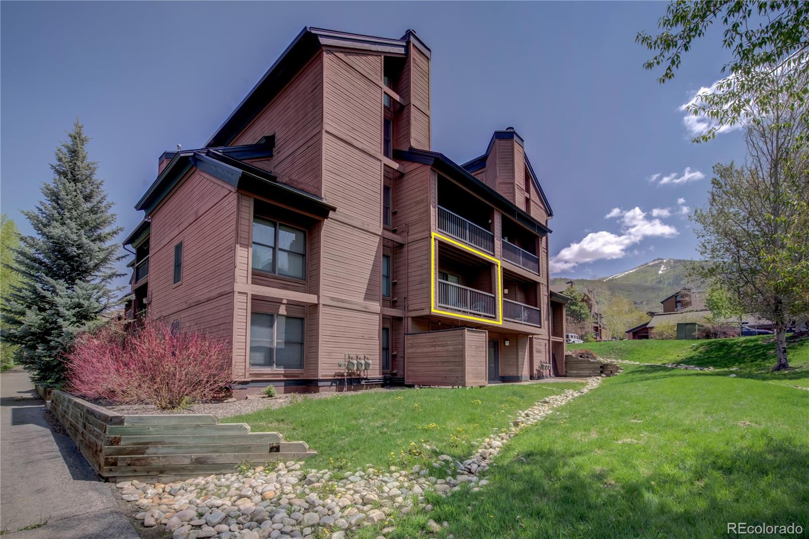 2015 Walton Creek Road, Unit 114 Steamboat Springs, CO 80487 - Photo 26 of 29 a view of a house with a yard
