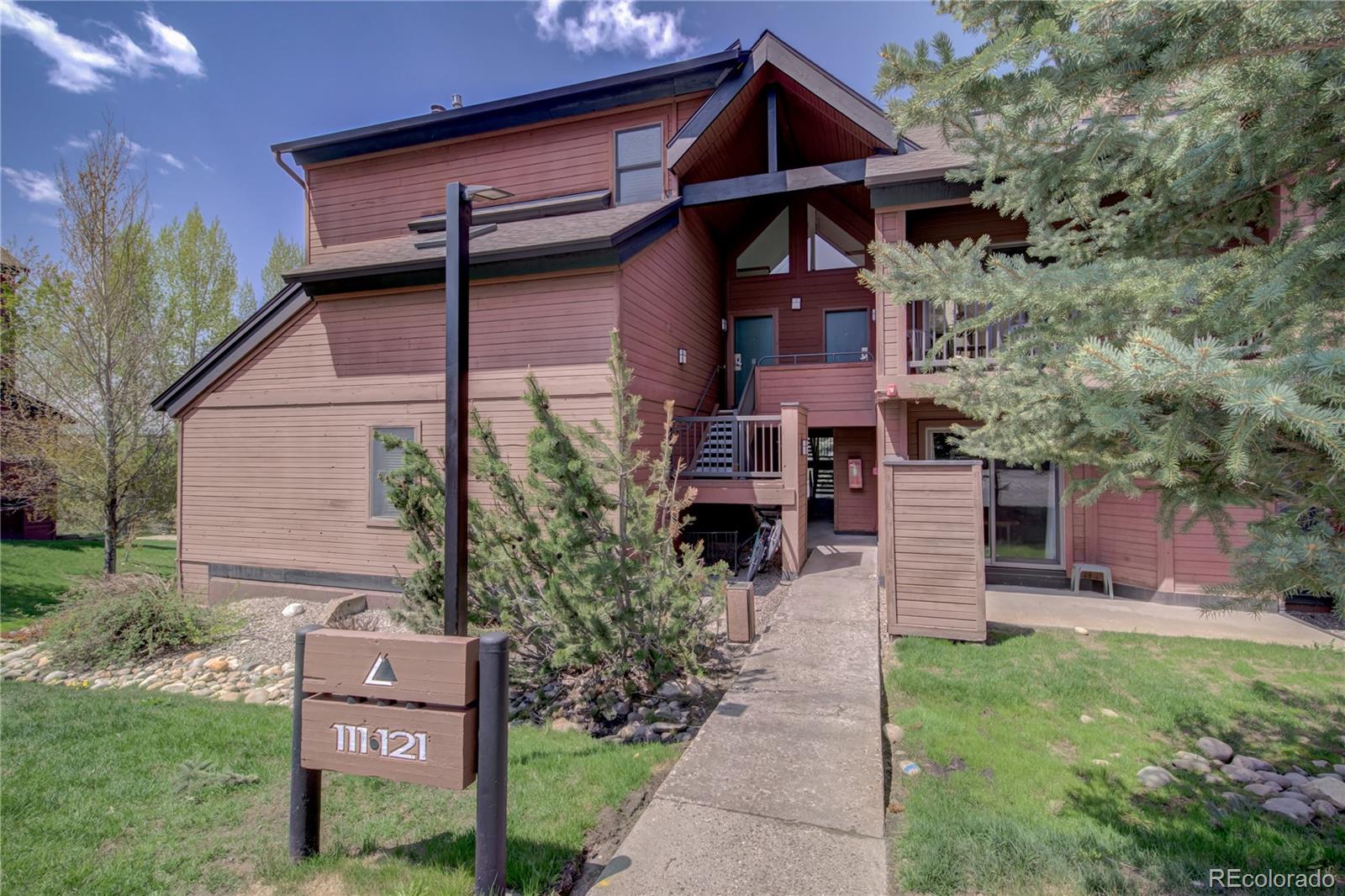 2015 Walton Creek Road, Unit 114 Steamboat Springs, CO 80487 - Photo 28 of 29 a front view of a house with garden