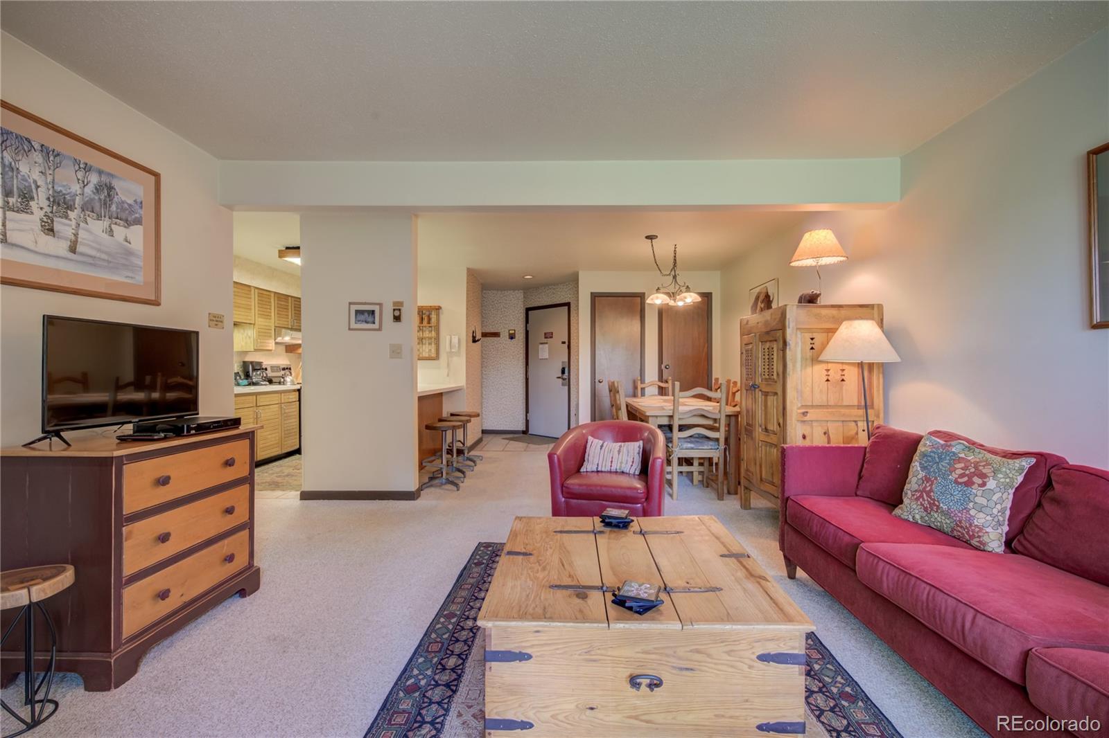 2015 Walton Creek Road, Unit 114 Steamboat Springs, CO 80487 - Photo 5 of 29 a living room with furniture and a flat screen tv