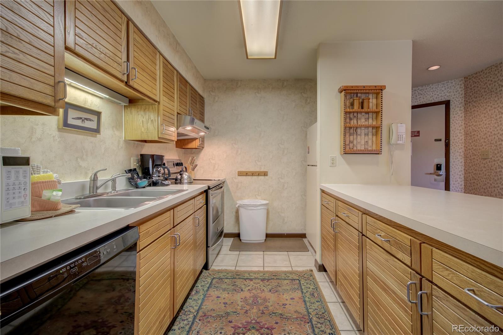 2015 Walton Creek Road, Unit 114 Steamboat Springs, CO 80487 - Photo 8 of 29 a kitchen with a sink and cabinets