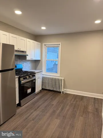a kitchen with granite countertop a stove and a refrigerator
