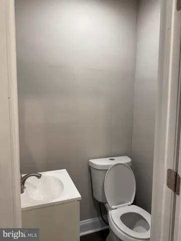 a white toilet sitting next to a white sink