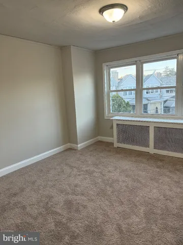 an empty room with large windows