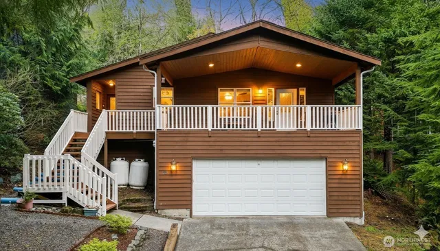 a view of a house with a yard and stairs
