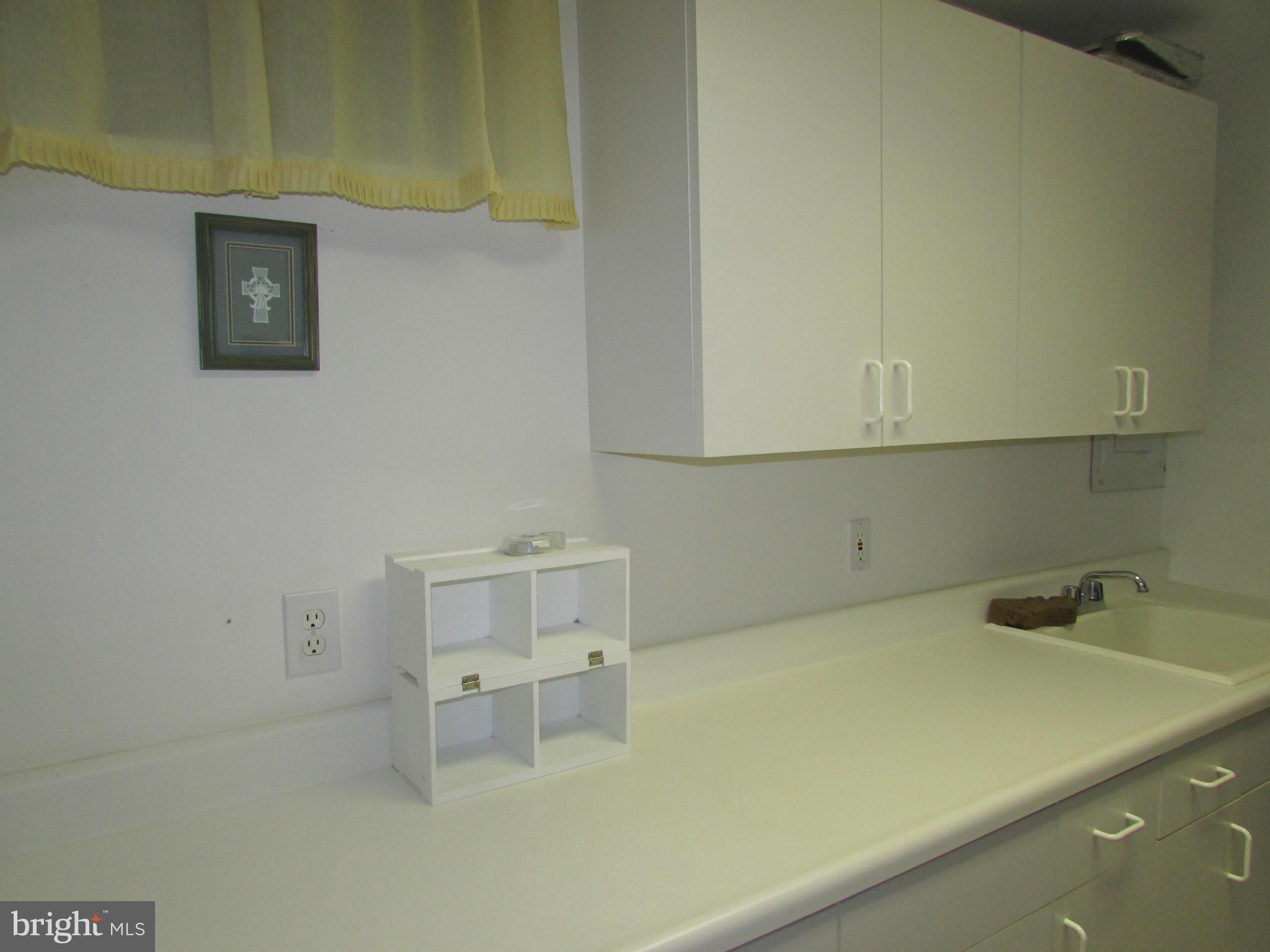 6808 Compton Valley Place Centreville, VA 20121 - Photo 13 of 16 a bathroom with a sink and cabinets