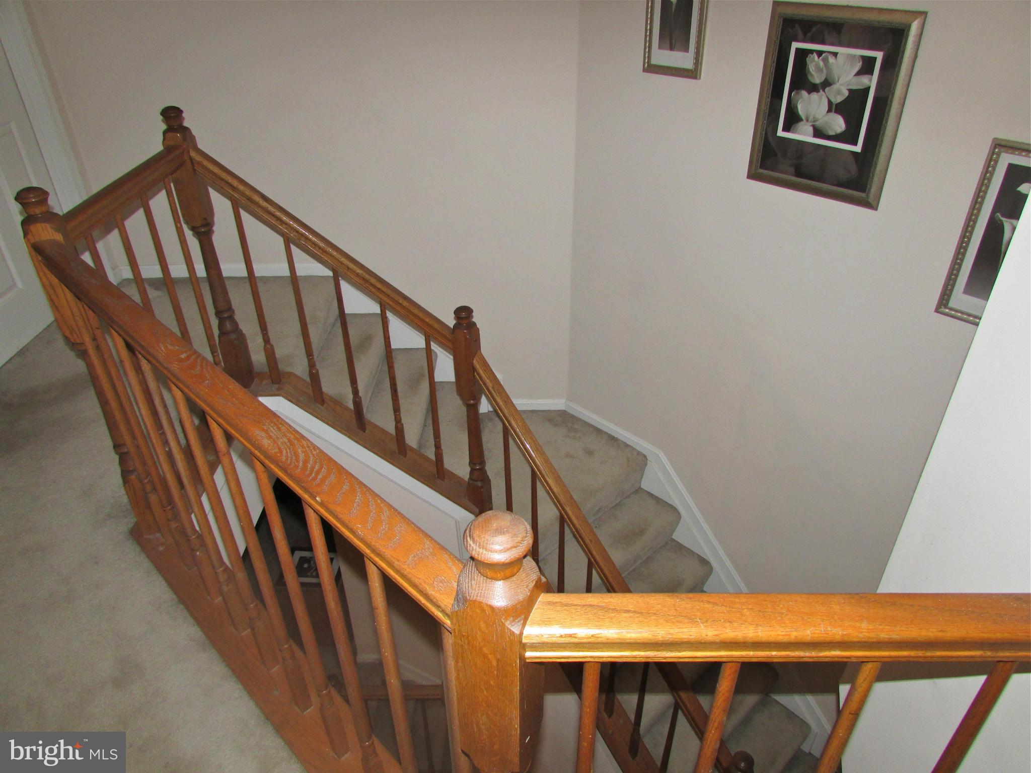 6808 Compton Valley Place Centreville, VA 20121 - Photo 8 of 16 a view of staircase with railing and white walls