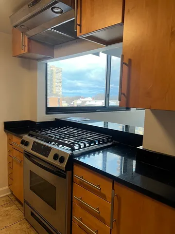 a stove top oven sitting inside of a kitchen