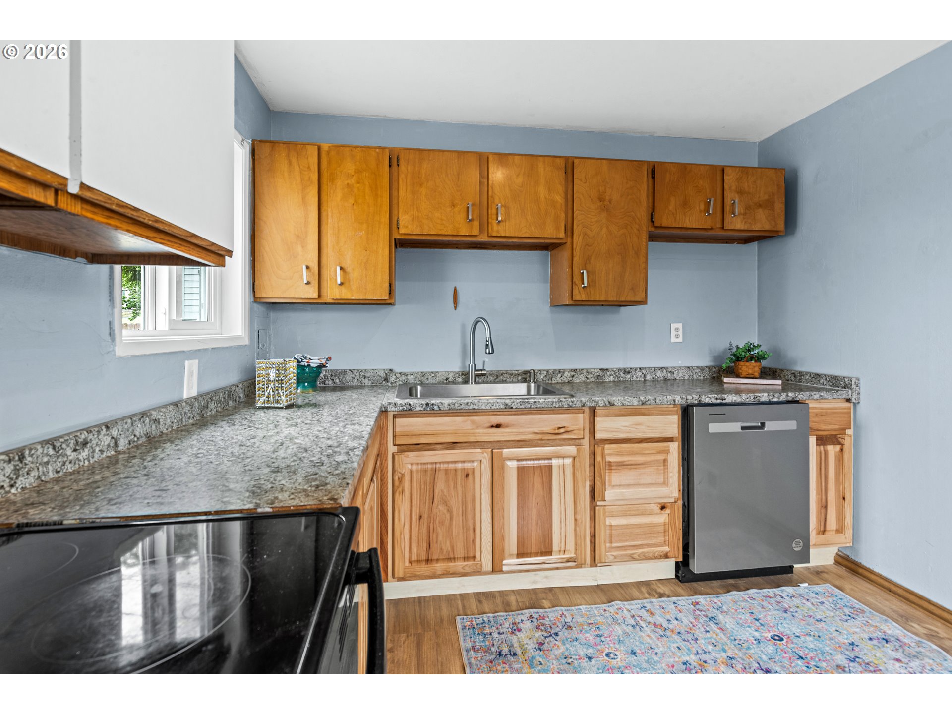 3009 Southwest Isaac Avenue Pendleton, OR 97801 - Photo 11 of 28 a kitchen with granite countertop a sink cabinets and wooden floor