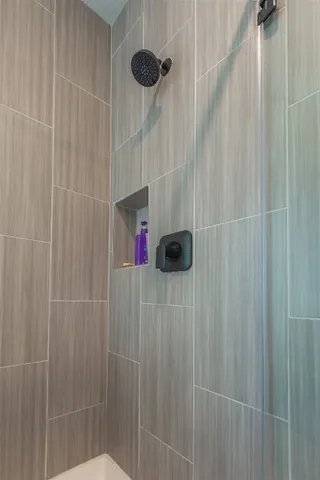 a bathroom with a bathtub a toilet and a shower